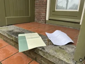 Gevouwen energiecertificaat op een lege drempel met huissleutels en een getekend overdrachtsformulier, zacht daglicht.